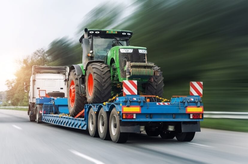 John Deere Tractor Being Hauled by a Semi Truck